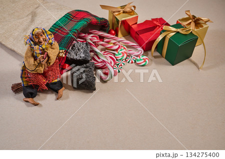 Epiphany Befana's stocking with sweet coal and candy. Italian Epiphany day. Epiphany Befana's stocking with sweet coal and candy. Italian Epiphany day. 134275400