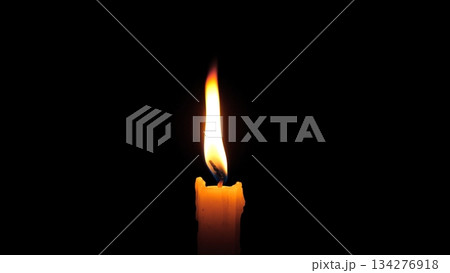 Solitary Candle Flame Standing Against Darkness, Single Wick Glowing With Steady Light, Minimal Composition Evoking Hope And Resilience, Crisp Contrast Highlighting Delicate Flame Shape 134276918