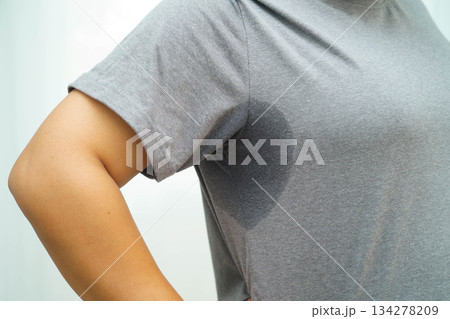Sweaty underarms, Asian woman with sweat on clothes under armpit. 134278209