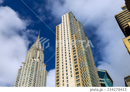 High rise Manhattan buildings reach towards sky in New York City 134278415