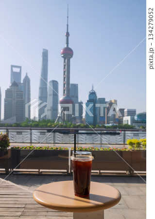 Ice americano coffee on cafe table with Pearl tower view, Shanghai 134279052