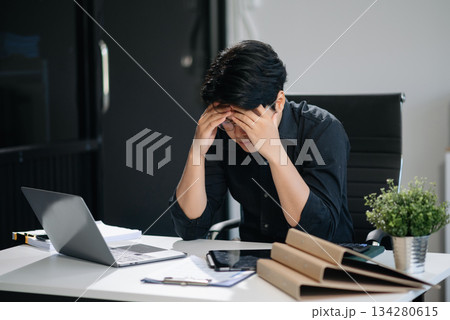 Businessman who is tired and overthinking from working with tablet and laptop 134280615
