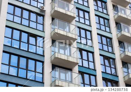 Contemporary city building, Modern residential tower featuring reflective windows and minimal design Contemporary city building, Modern residential tower featuring reflective windows and minimal design 134280738