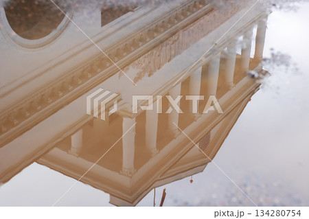 Architectural symmetry and historic features reflected on rainwater in urban setting Architectural symmetry and historic features reflected on rainwater in urban setting 134280754