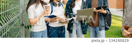 Young Asian People college students and a female student group work at the campus park in morning with her friend 134280829