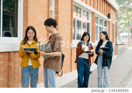 Young Asian People college students and a female student group work at the campus park in morning with her friend 134280893