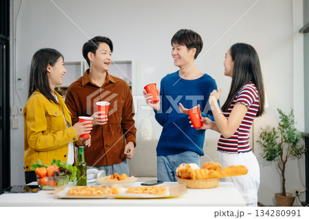 Young Asian friend having, enjoy evening party together at home. Attractive young man and woman having fun, eating food, celebrate at home 134280991