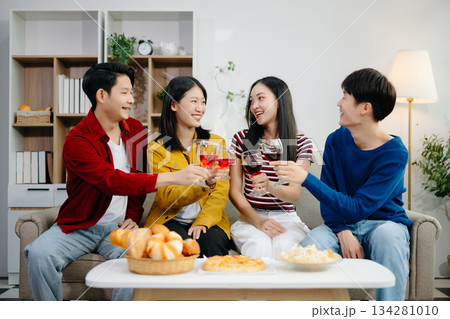 Young Asian friend having, enjoy evening party together at home. Attractive young man and woman having fun, eating food, celebrate at home Young Asian friend having, enjoy evening party together at home. Attractive young man and woman having fun, eating food, celebrate at home 134281010