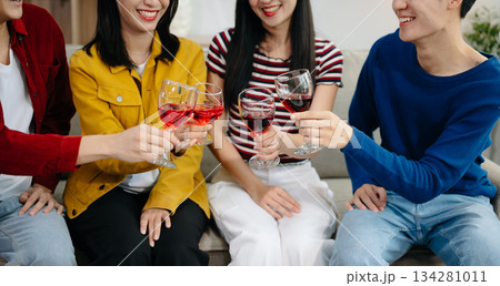 Young Asian friend having, enjoy evening party together at home. Attractive young man and woman having fun, eating food, celebrate at home 134281011