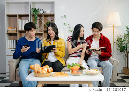 Young Asian friend having, enjoy evening party together at home. Attractive young man and woman having fun, eating food, celebrate at home 134281017