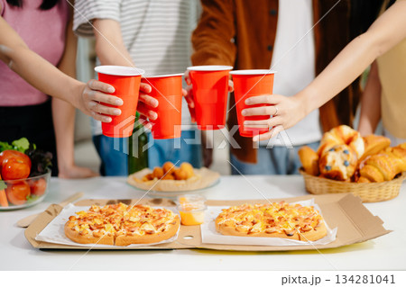 Young Asian friend having, enjoy evening party together at home. Attractive young man and woman having fun, eating food, celebrate at home 134281041