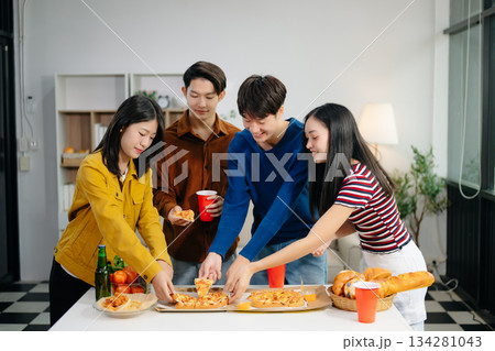 Young Asian friend having, enjoy evening party together at home. Attractive young man and woman having fun, eating food, celebrate at home Young Asian friend having, enjoy evening party together at home. Attractive young man and woman having fun, eating food, celebrate at home 134281043