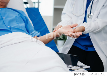 Medical doctor holing senior patient's hands and comforting her Medical doctor holing senior patient's hands and comforting her 134281149