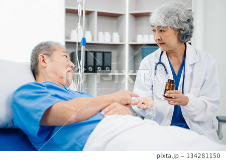 Medical doctor holing senior patient's hands and comforting her 134281150