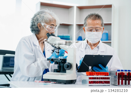 Scientist team meeting and writing analysis results in the laboratory study Scientist team meeting and writing analysis results in the laboratory study 134281210