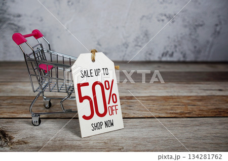 Sale 50% off text with trolley shopping cart on wooden background 134281762