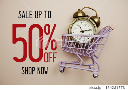 Sale 50% off text with alarm clock and trolley shopping cart on pink background 134281778