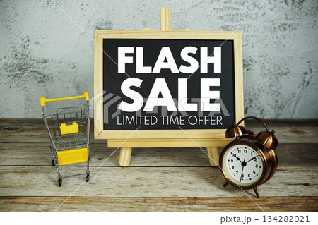Flash Sale Limited Time Offer text on blackboard with alarm clock and trolley shopping cart Flash Sale Limited Time Offer text on blackboard with alarm clock and trolley shopping cart 134282021