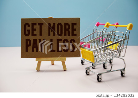 Get More Pay Less Sign Board and Mini Shopping Cart on Pastel Background 134282032