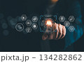 Businessman pointing at glowing AI agents icon with futuristic digital interface, representing artificial intelligence, automation, data analysis, machine learning, and innovative business solutions 134282862