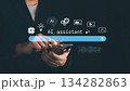 Modern concept of AI assistant with business person using smartphone and virtual interface icons. Innovation, artificial intelligence, and digital technology for smart communication 134282863