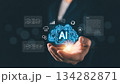 Businessman holding glowing AI brain icon with digital data and technology symbols, representing artificial intelligence, innovation, big data, machine learning, and future business solutions 134282871