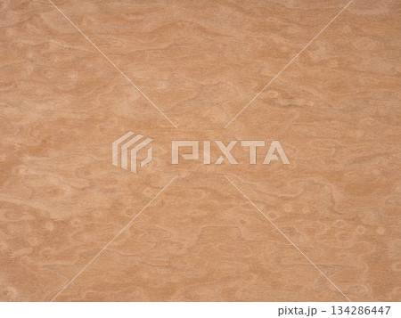 Warm caramel tones meander in an organic marbled pattern on a soft veneer surface 134286447