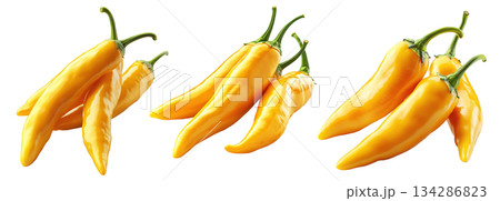 Yellow chili peppers with green stems isolated on a white transparent background. Spicy food and cooking ingredient concept 134286823