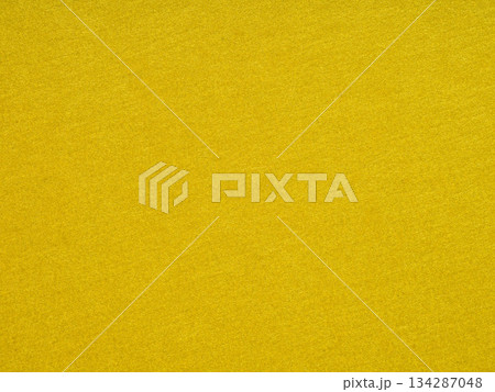 A vibrant yellow hue saturates the textured surface, conveying warmth, happiness, and creative inspiration A vibrant yellow hue saturates the textured surface, conveying warmth, happiness, and creative inspiration 134287048