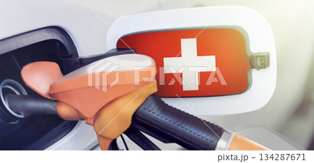 The Swiss flag on the lid of the gas tank of a car at a gas station in close-up. High or low gasoline prices at Swiss gas stations. Gasoline prices are rising due to a shortage of diesel fuel. 134287671
