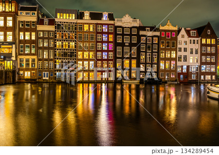 Amsterdam night. Colorful houses and canal water Amsterdam night. Colorful houses and canal water 134289454