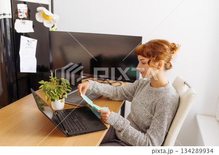Young woman using multiple laptops for video conferencing at home office Young woman using multiple laptops for video conferencing at home office 134289934
