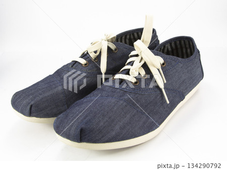 Pair of simple gumshoes (sneakers) on a white background 134290792