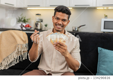 Indian man counts euro cash happy makes money gesture plans dream purchase savings bonus invest plan Indian man counts euro cash happy makes money gesture plans dream purchase savings bonus invest plan 134290816
