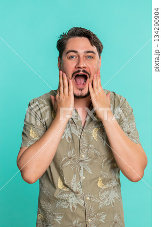 Adult man opens mouth shocked by unexpected win or success showing wow emotion with amazed reaction Adult man opens mouth shocked by unexpected win or success showing wow emotion with amazed reaction 134290904