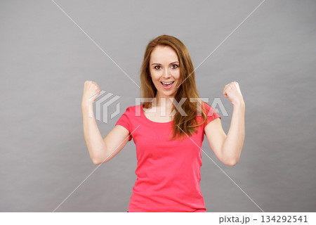 Joyful woman screaming yes clenching fists Joyful woman screaming yes clenching fists 134292541