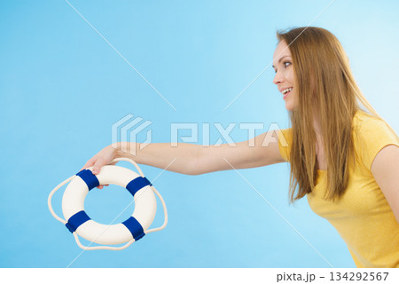Girl holds life buoy rescue ring Girl holds life buoy rescue ring 134292567