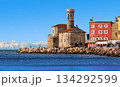 A view of Our Lady of Health Church in the old Slovenian town of Piran. Cityscape of Piran with snowy mountains in the background 134292599