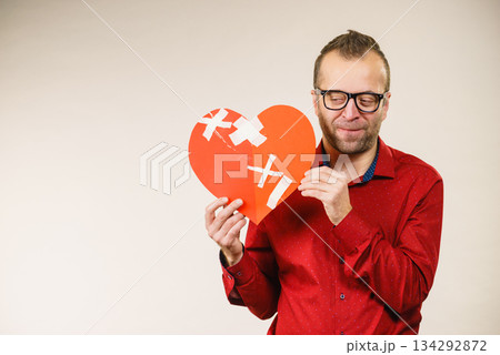 Adult man holding broken heart Adult man holding broken heart 134292872