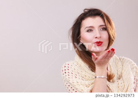 Young woman blowing kiss. 134292973
