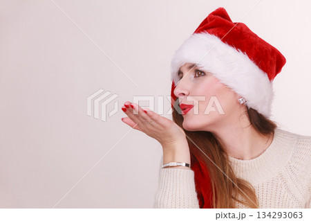 Christmas woman blowing a kiss Christmas woman blowing a kiss 134293063
