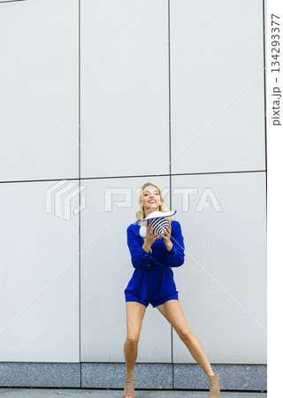 Fashion model playing with hat 134293377
