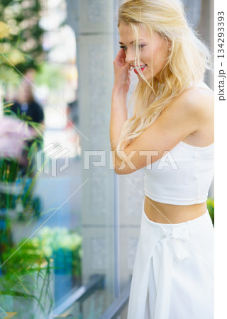 Elegant woman looking at shop window 134293393