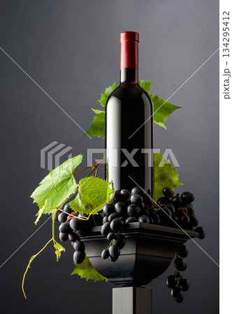 Bottle of red on a black podium. Bottle of red on a black podium. 134295412