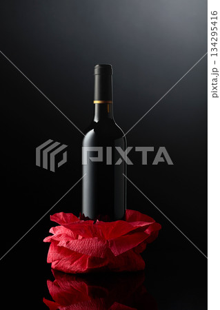 Bottle of red wine on a crumpled paper. 134295416