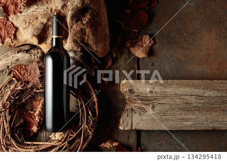 Bottle of red wine on a vintage rustic background. 134295418