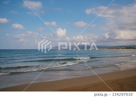 Vibrant seascape: deep azure waters under a clear sky with scattered white clouds 134297010