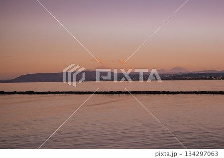 violet seascape with soft twilight hues and distant silhouettes violet seascape with soft twilight hues and distant silhouettes 134297063