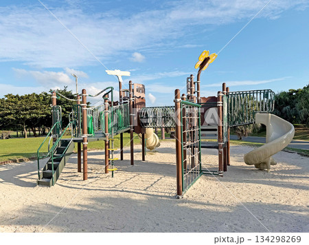 Modern playground equipment with slides and climbing structures on a sunny day 134298269