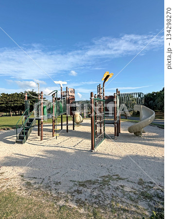 Modern playground equipment with slides and climbing structures on a sunny day 134298270